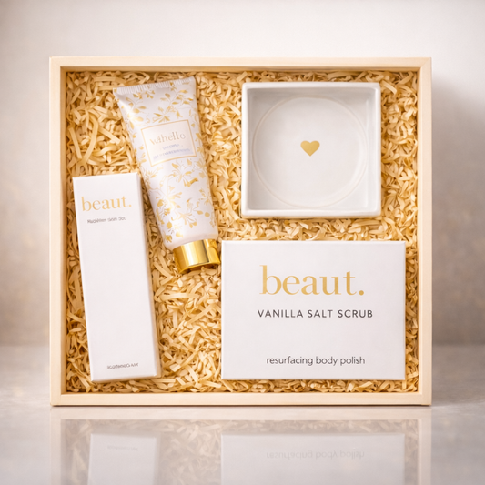 Birthday self-care gift box with vanilla salt scrub hand cream serum and heart dish on a clean neutral background