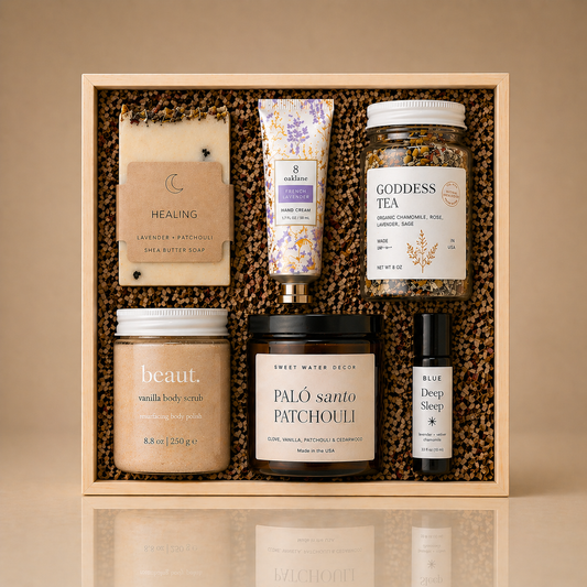 Deep Relaxation Ritual gift box with Healing shea butter soap, French lavender hand cream, Goddess Tea, vanilla body scrub, Palo Santo Patchouli candle, and Deep Sleep roll-on in a wooden box on a neutral background