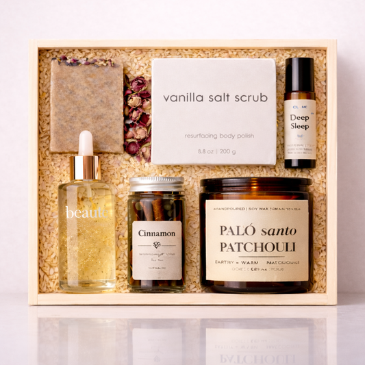 Self-care gift box with vanilla salt scrub serum candle cinnamon soap and sleep oil on a clean neutral background